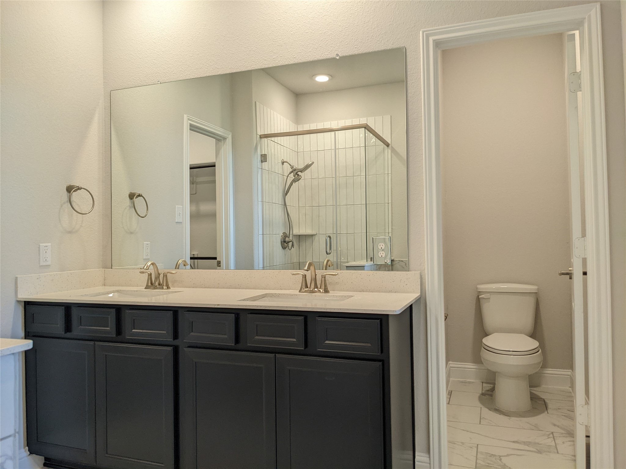 15311 Leal Rancho Court Cypress, TX 77433 - Photo 15 of 20 a bathroom with a granite countertop sink a toilet and a mirror