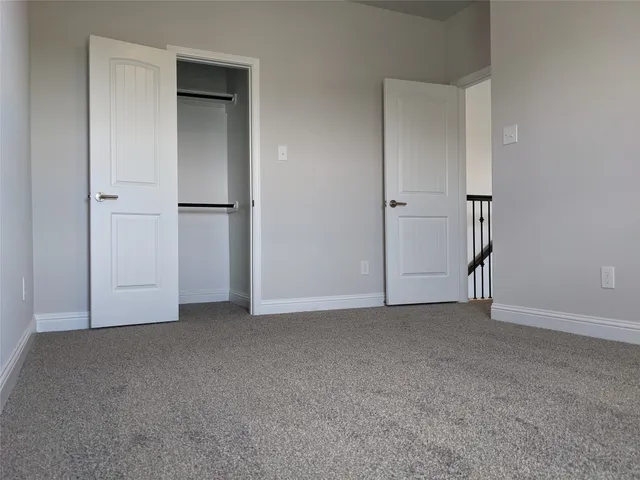a view of an empty room with closet area