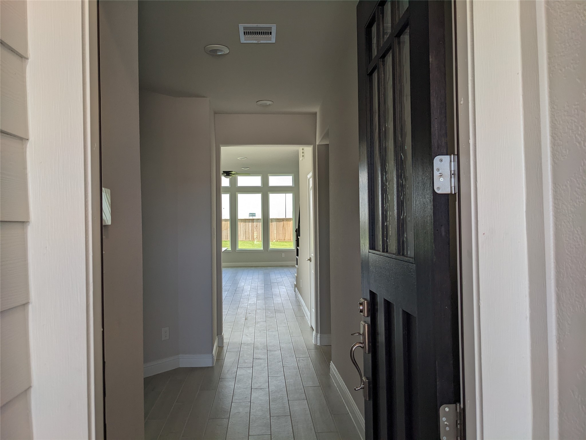 15311 Leal Rancho Court Cypress, TX 77433 - Photo 3 of 20 a view of a hallway with wooden floor and a living room