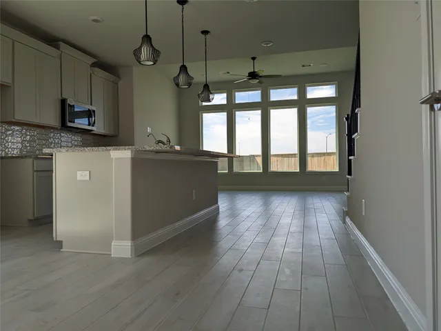 a view of a kitchen with a sink and dishwasher wooden floor