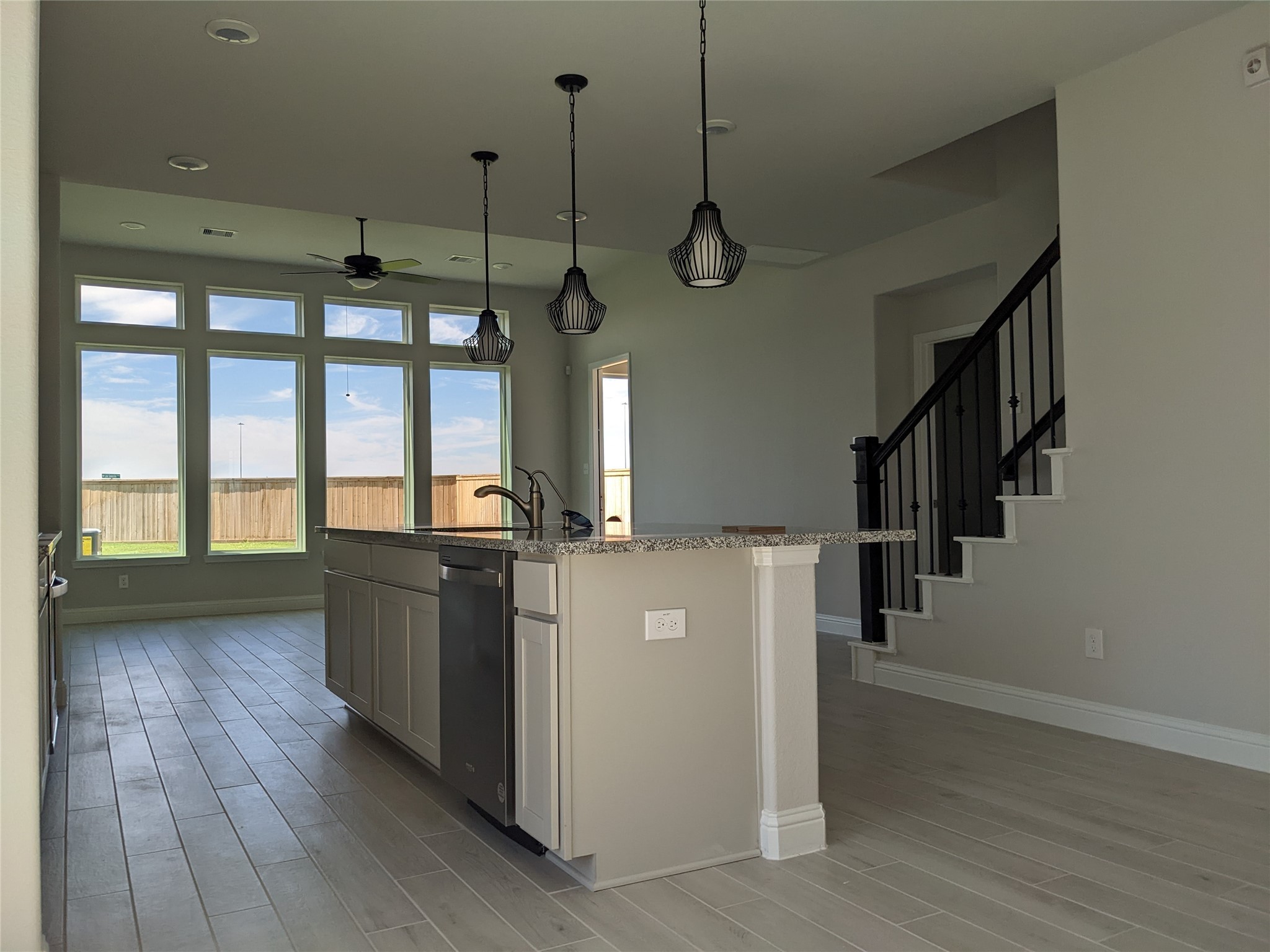 15311 Leal Rancho Court Cypress, TX 77433 - Photo 8 of 20 a kitchen with kitchen island wooden floor center island stainless steel appliances and wooden floor