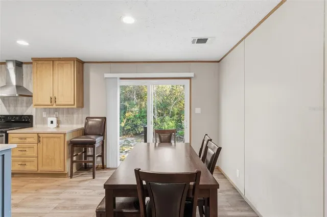 a view of a dining room with furniture and window