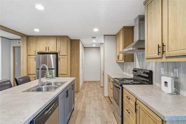a kitchen with stainless steel appliances granite countertop a sink stove and refrigerator