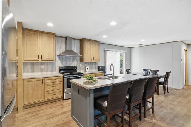 a kitchen with a stove a sink a dining table and chairs