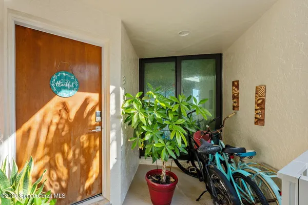 a living room with lots of furniture and kitchen view