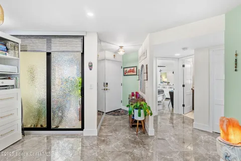 a living room with lots of furniture and kitchen view