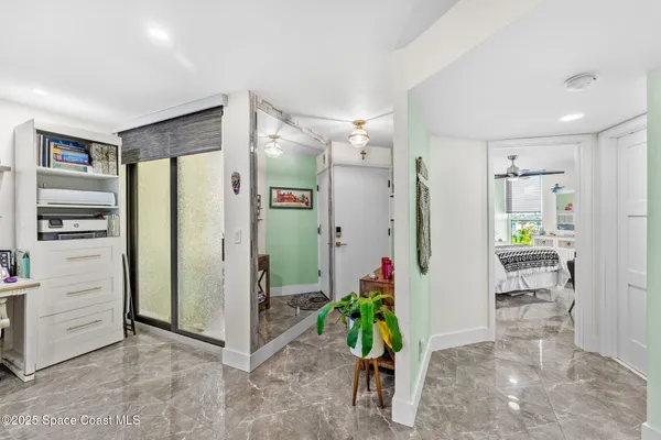 a living room with furniture and potted plant