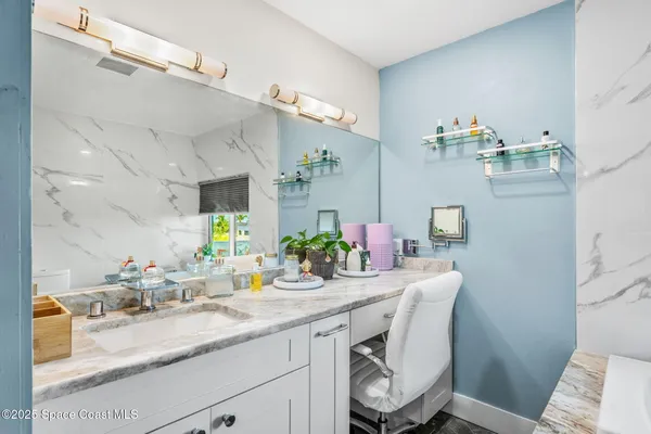 a spacious bathroom with a sink and garden view