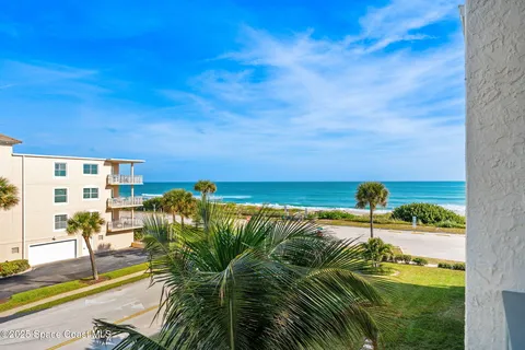 an aerial view of residential houses with outdoor space and swimming pool