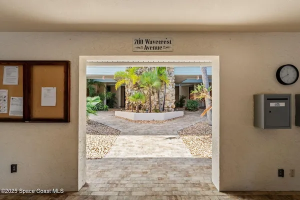 a view of staircase with railing and white walls