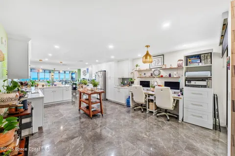 a view of staircase with railing and white walls