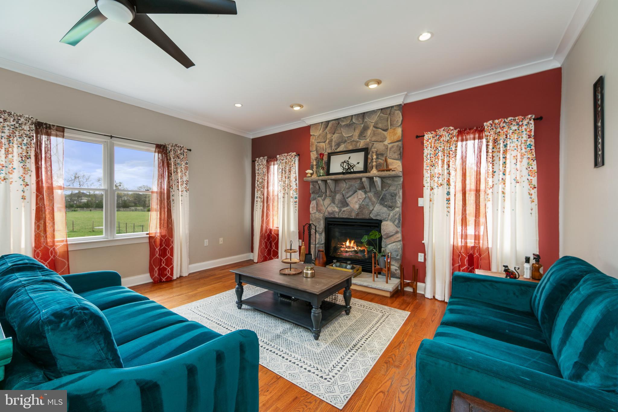 173 West Pleasant Grove Road Jackson, NJ 08527 - Photo 19 of 47 a living room with furniture a fireplace and a large window