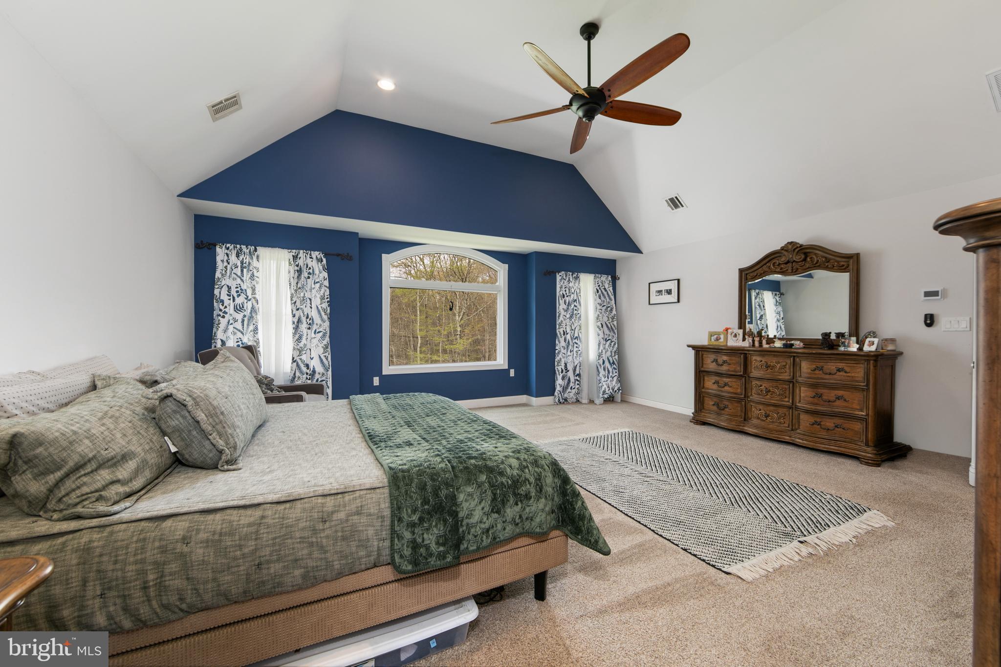 173 West Pleasant Grove Road Jackson, NJ 08527 - Photo 26 of 47 a bedroom with a large bed and a chandelier