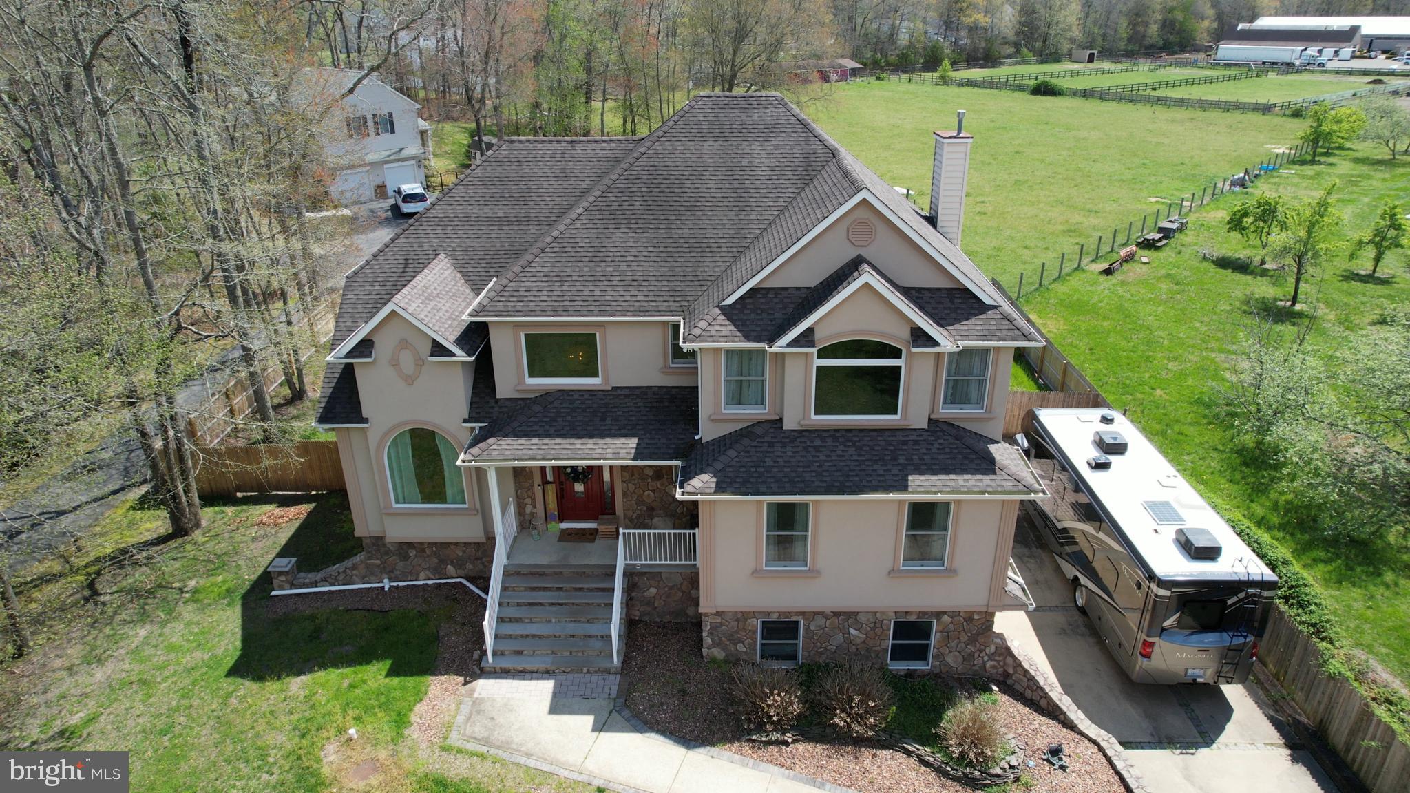 173 West Pleasant Grove Road Jackson, NJ 08527 - Photo 3 of 47 a aerial view of a house next to a big yard and large trees
