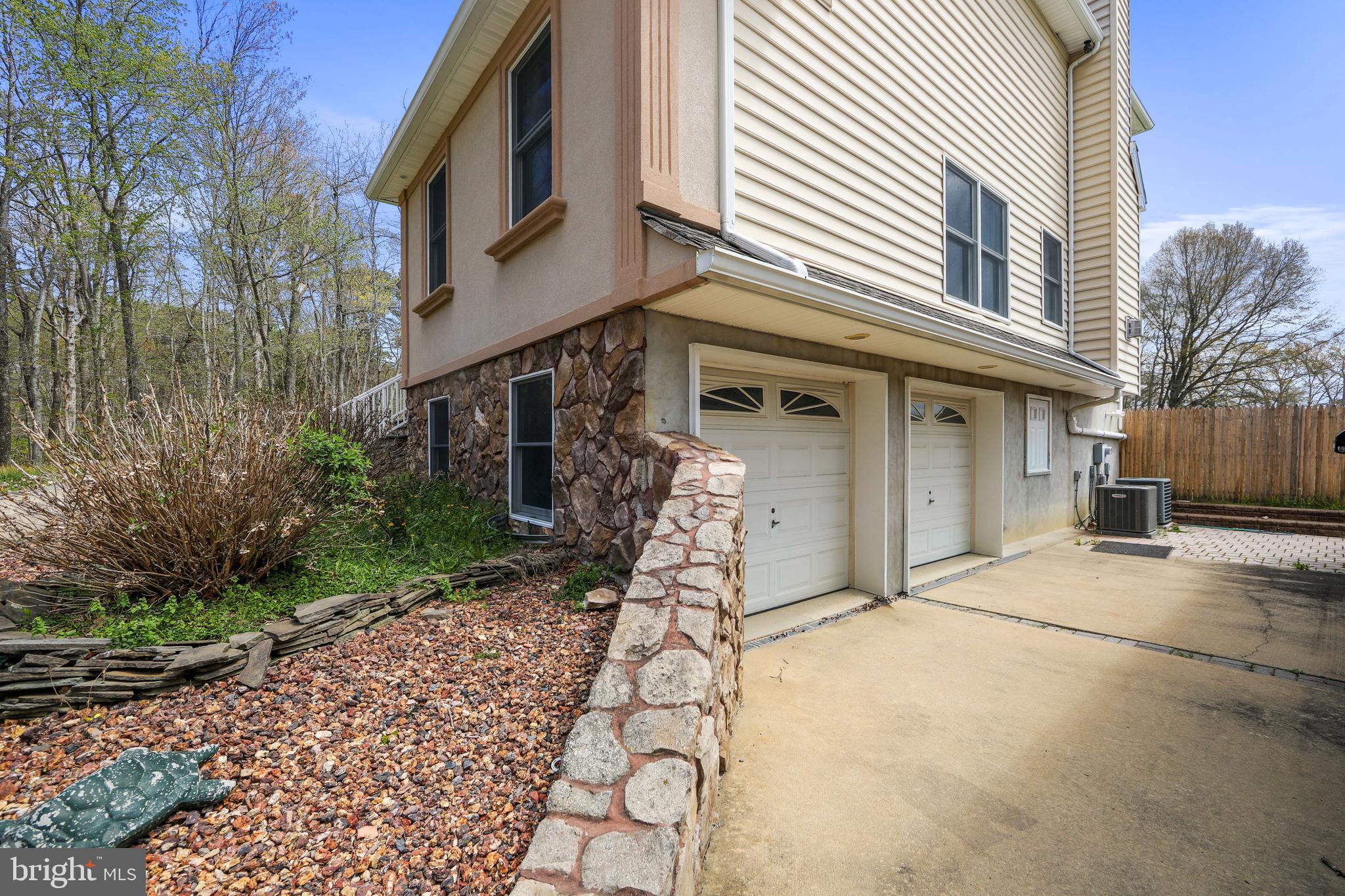 173 West Pleasant Grove Road Jackson, NJ 08527 - Photo 5 of 47 a front view of a building with garden