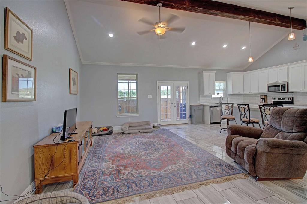 8789 Hutcheson Hill Road Springtown, TX 76082 - Photo 6 of 29 Living room featuring French doors, beam ceiling, ceiling fan, high vaulted ceiling, and recessed lighting