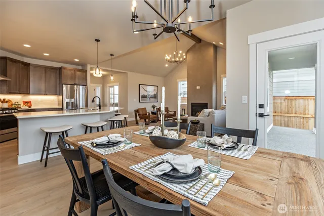 a kitchen with kitchen island granite countertop a sink stainless steel appliances and cabinets