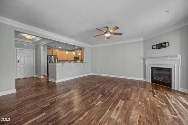 a view of empty room with wooden floor and fireplace