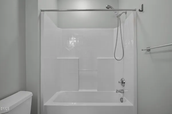 a bathroom with a shower and a bath tub