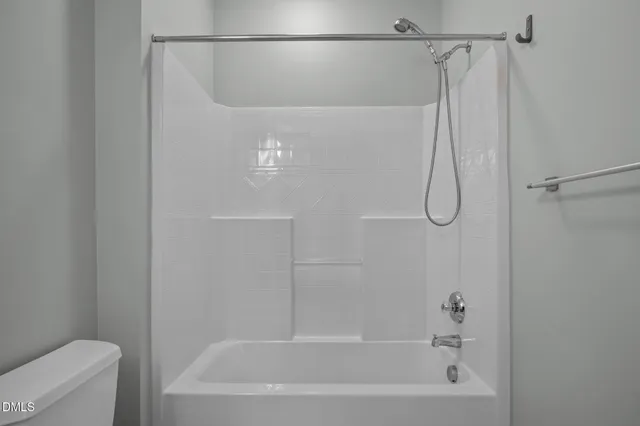 a bathroom with a shower and a bath tub
