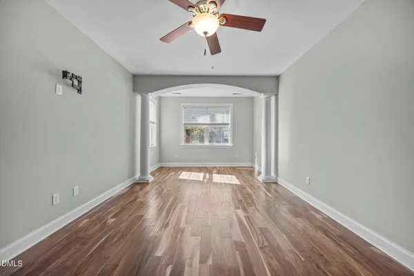 wooden floor in an empty room with a window