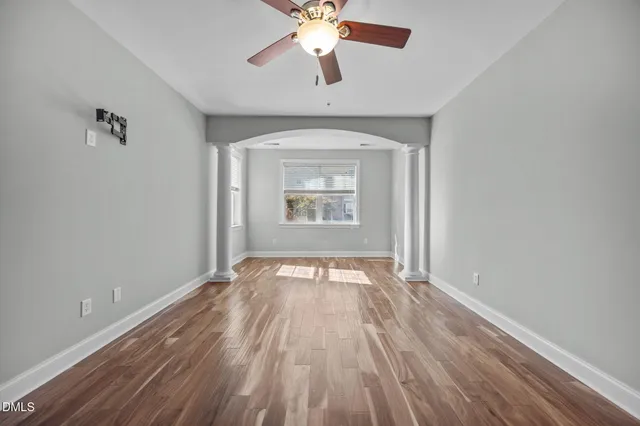 wooden floor in an empty room with a window