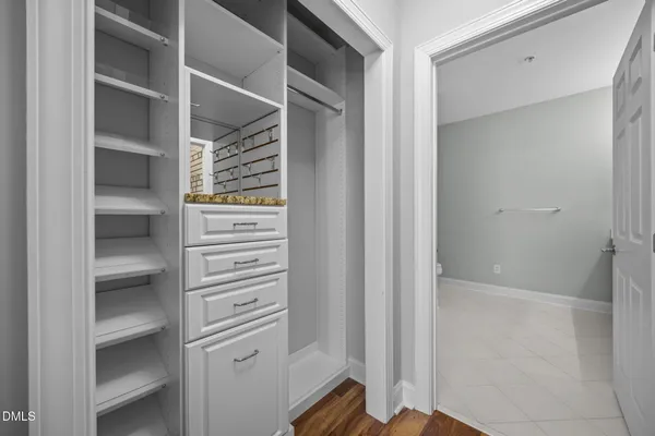 a view of walk in closet with empty racks
