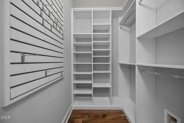 a view of walk in closet with empty racks