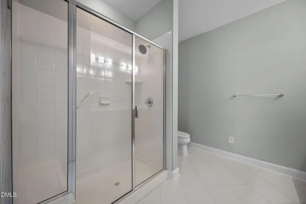 a bathroom with a glass shower door