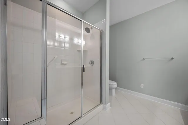 a bathroom with a glass shower door