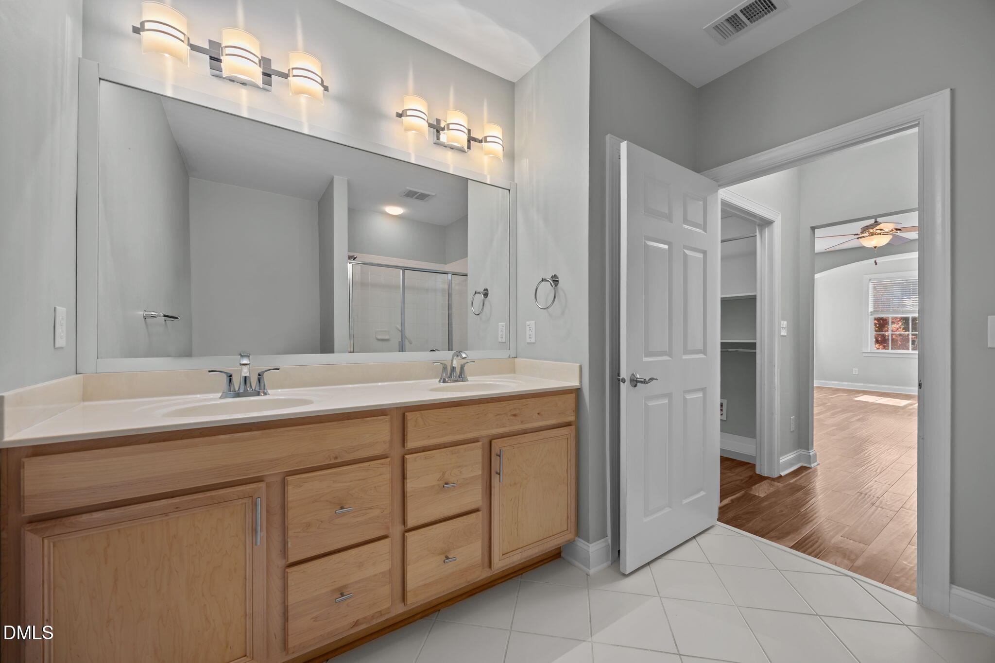 10410 Rosegate Court, Unit 201 Raleigh, NC 27617 - Photo 29 of 46 a bathroom with a double vanity sink and a mirror