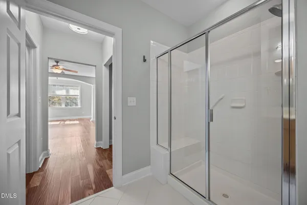 a bathroom with a shower and a glass door