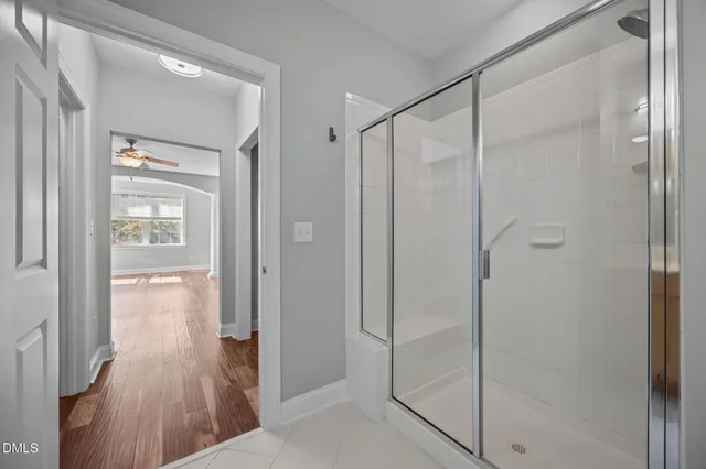 a bathroom with a shower and a glass door