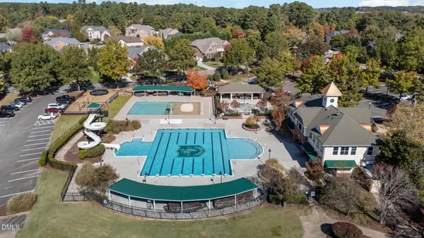 an aerial view of a house with a swimming pool outdoor seating yard and mountain view