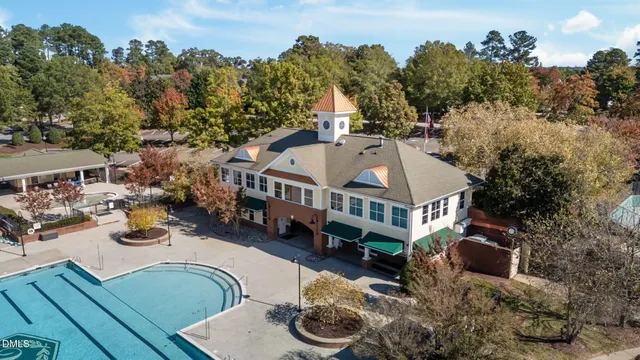 an aerial view of a house with swimming pool and sitting area