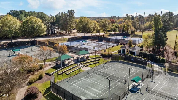 an aerial view of a swimming pool with a yard and mountain view in back