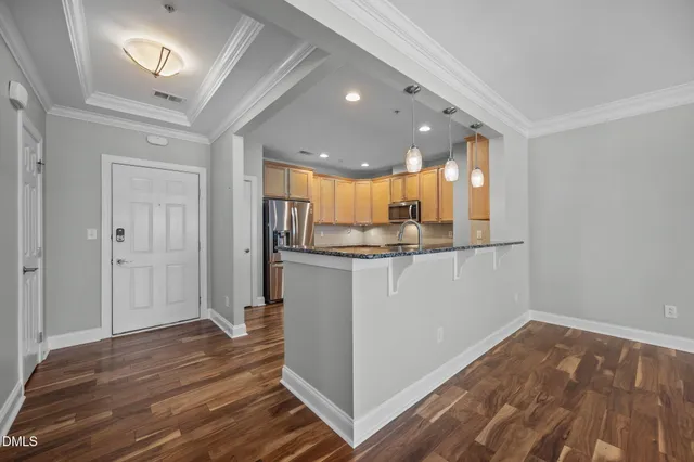 a view of kitchen and hall with wooden floor