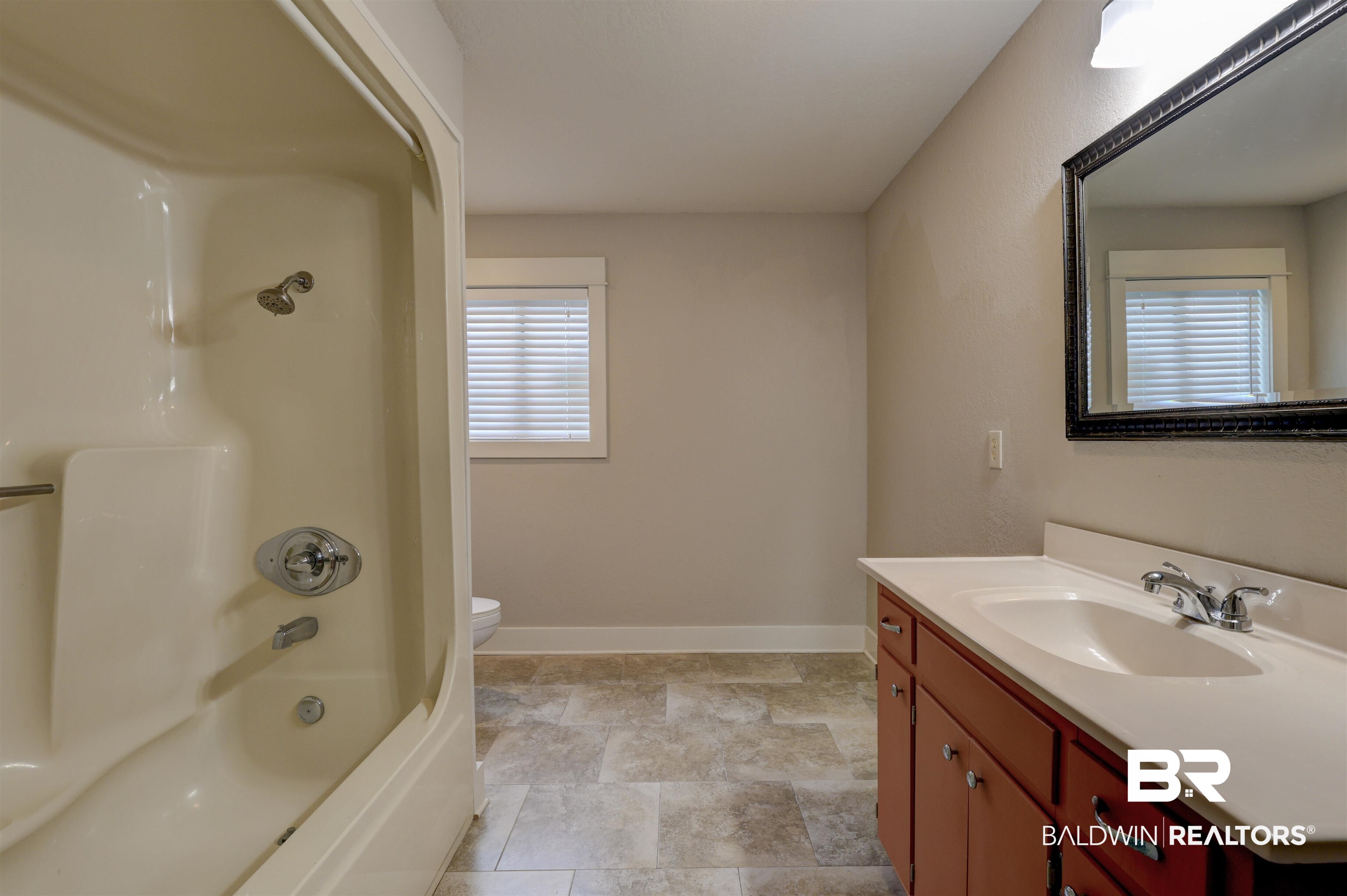 2079 Alabama Street Loxley, AL 36551 - Photo 27 of 42 Full bathroom with shower / tub combination, toilet, vanity, and plenty of natural light