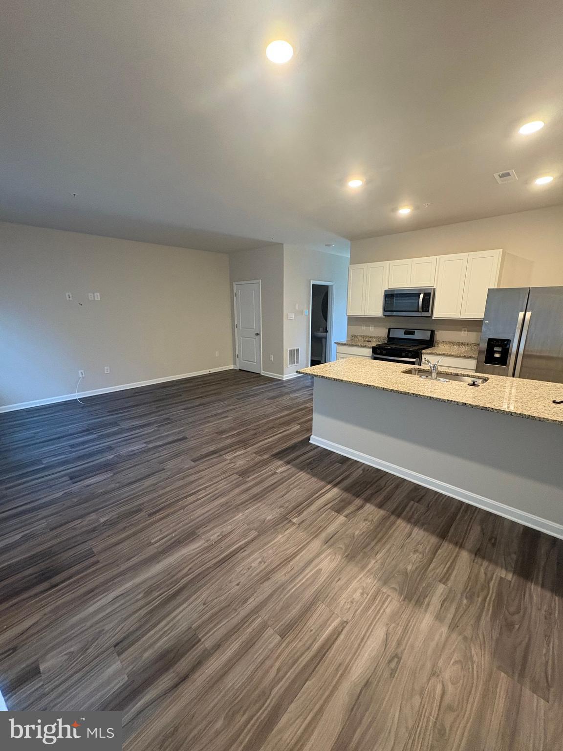 410 Maple Run Drive York, PA 17404 - Photo 7 of 19 a large white kitchen with wooden floors and stainless steel appliances