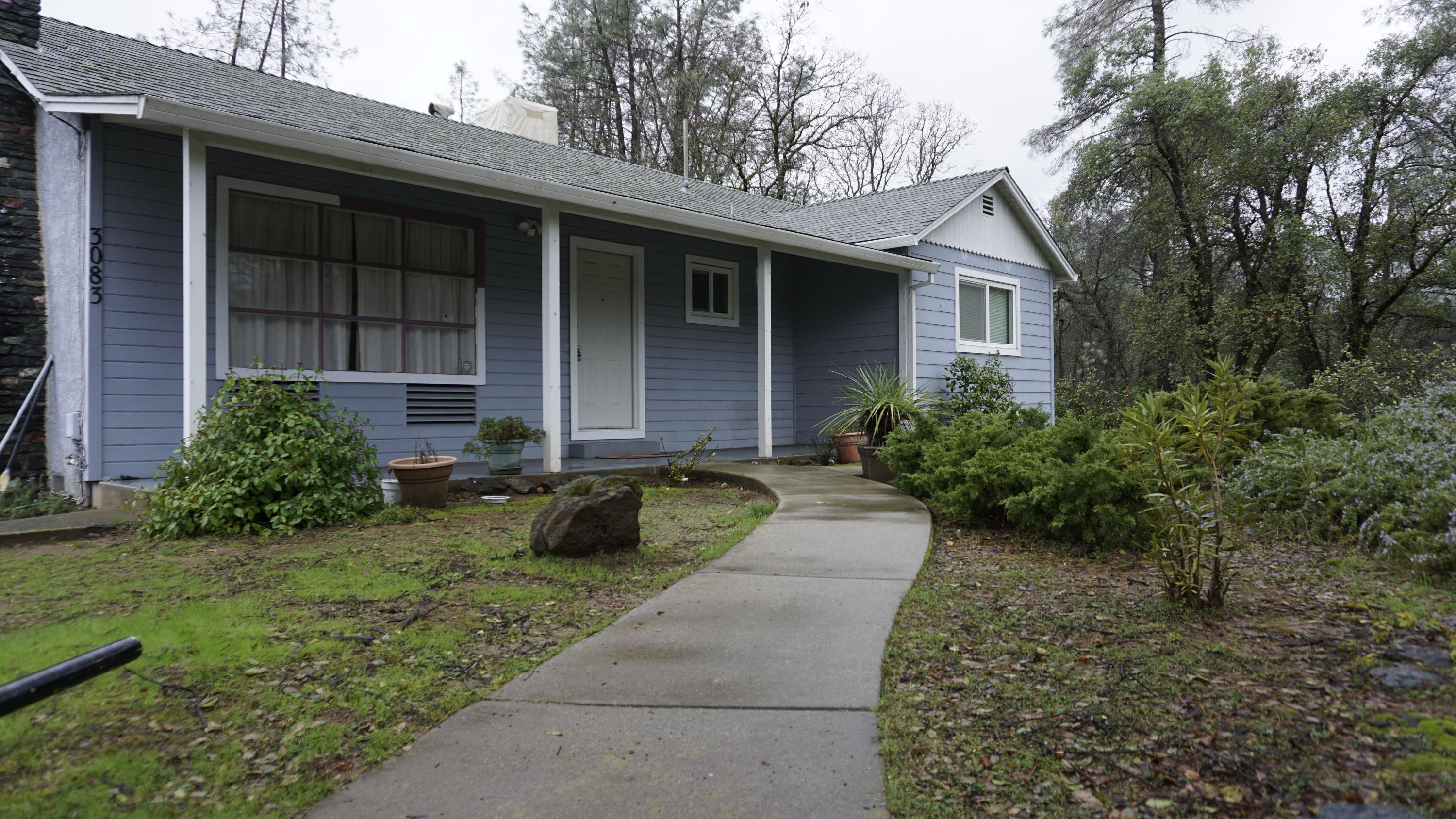 3083 Keswick Dam Road Redding, CA 96003 - Photo 1 of 19 a front view of a house with garden