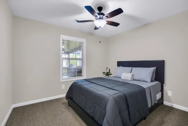 a bedroom with a large bed and a window
