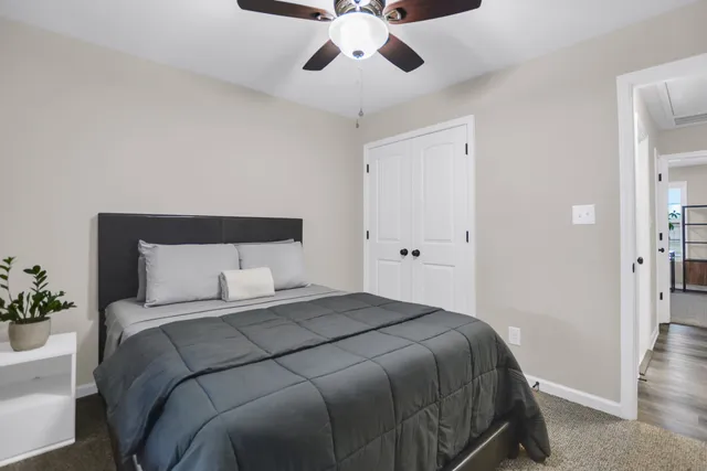a bedroom with a large bed and a chandelier