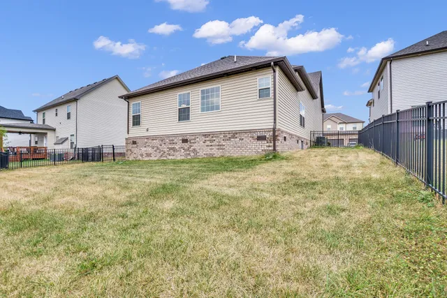 a view of a house with a yard and sitting area