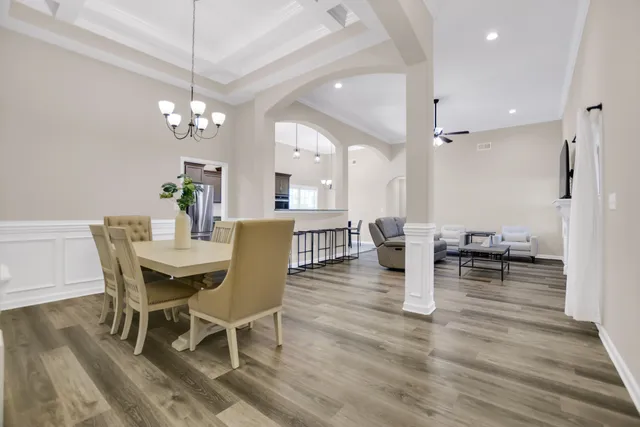 a view of a dining room with furniture and wooden floor
