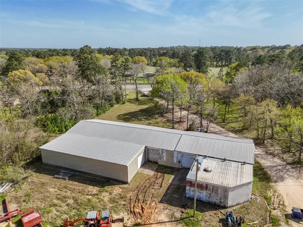 an aerial view of a house with a yard and lake view