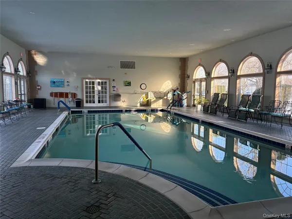 a living room with furniture pool table and a large window