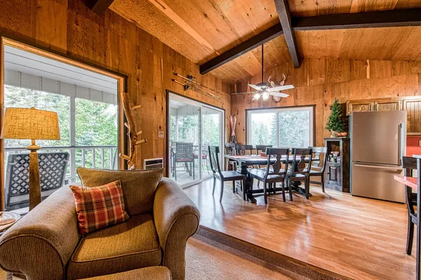 a dining room with furniture window and wooden floor