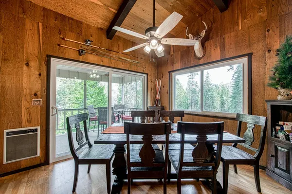 a dining room with furniture window and wooden floor