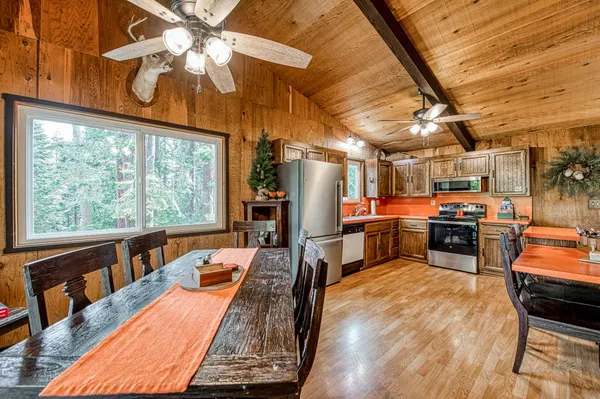 a kitchen with stainless steel appliances kitchen island granite countertop a stove and a refrigerator