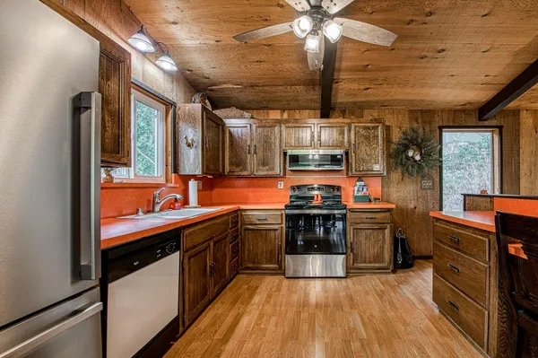 a kitchen with stainless steel appliances granite countertop a sink and stove